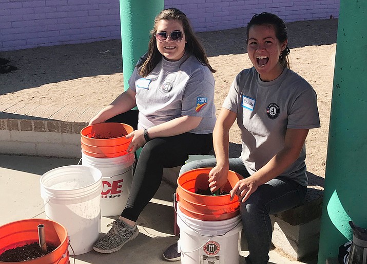 AmeriCorps state member Christina Arrington, left, and AmeriCorps VISTA member Abby Cowan prepare soil for a community garden, much like some of the environmental projects initiated by Youth Conservation Corps. (Courtesy)