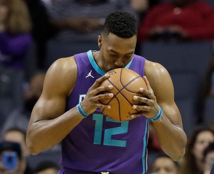 In this April 8, 2018, file photo, Charlotte Hornets’ Dwight Howard (12) kisses the basketball before the start of an NBA basketball game against the Indiana Pacers in Charlotte, N.C. (Chuck Burton/AP, File)
