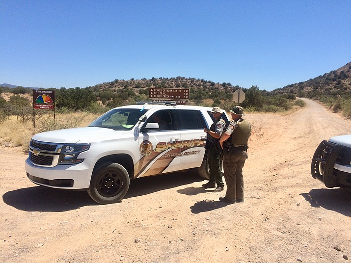 Yavapai County Sheriff's officers and special weapons teams from surrounding communities are assisting with the search for a murder suspect. According to YCSO, the murder happened in Prescott Thursday morning, June 21, 2018. The search for the suspect is currently taking place in the Rimrock, Arizona area. Pictured above, deputies close Forest Road 119. (Vyto Starinskas, Verde Independent)