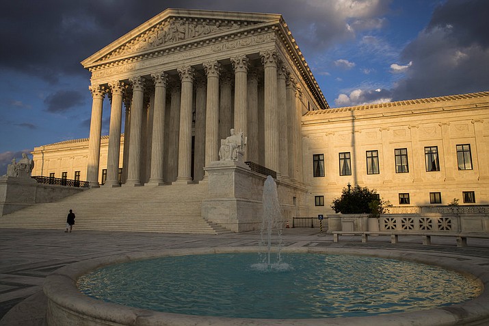 The Supreme Court in Washington is seen at sunset. In a 5-4 decision Friday, The Supreme Court says police generally need a search warrant if they want to track criminal suspects' movements by collecting information about where they've used their cellphones. (AP Photo/J. Scott Applewhite)
