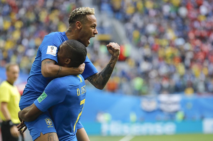 Brazil’s Neymar, top, celebrates with teammate Douglas Costa after scoring his second goal Friday, June 22, 2018, in St. Petersburg, Russia. (Dmitri Lovetsky/AP)