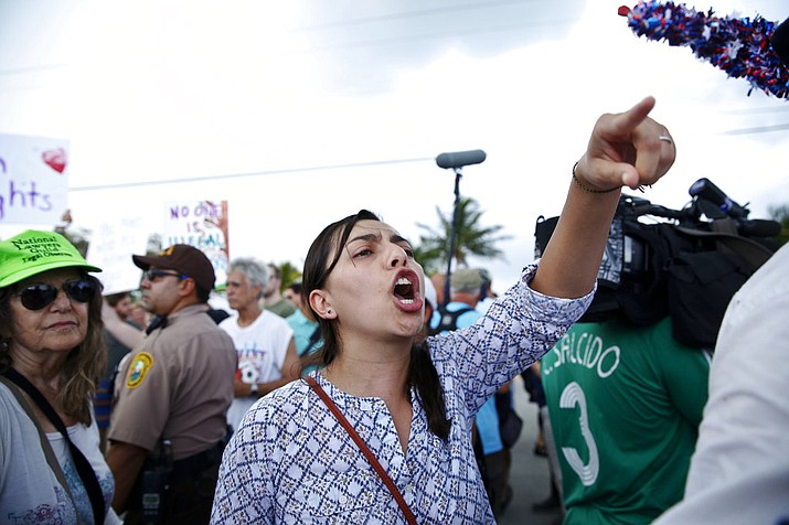 A protester yells toward a Trump supporter after arriving to the Homestead Temporary Shelter for Unaccompanied Children, on Saturday, June 23, 2018, in Homestead, Fla. (AP Photo/Brynn Anderson)