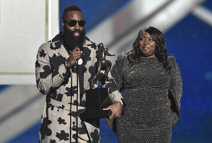 NBA player James Harden, of the Houston Rockets, left, accepts the most valuable player award as his mother, Monja Willis, looks on at the NBA Awards on Monday, June 25, 2018, at the Barker Hangar in Santa Monica, Calif. (Chris Pizzello/Invision/AP)