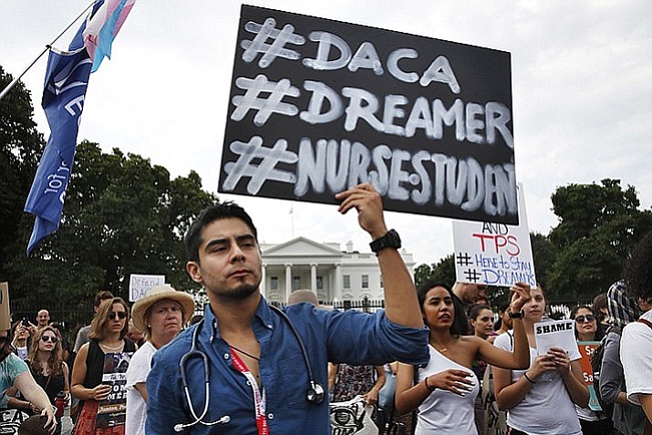 Carlos Esteban, 31, of Woodbridge, Va., a nursing student and recipient of Deferred Action for Childhood Arrivals, known as DACA, rallies with others in support of DACA outside of the White House, in Washington, Tuesday, Sept. 5, 2017. (Jacquelyn Martin/AP Photo)
