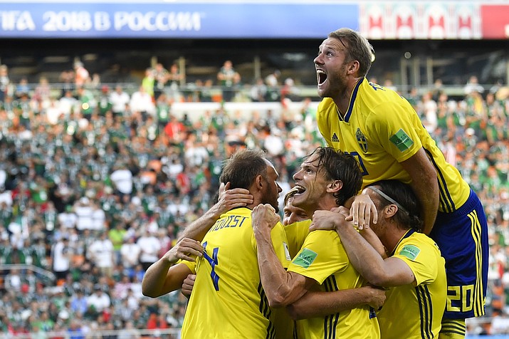 Sweden’s Andreas Granqvist, left, celebrates with teammates after scoring his side’s second goal during the group F match between Mexico and Sweden, at the 2018 soccer World Cup in the Yekaterinburg Arena in Yekaterinburg , Russia, Wednesday, June 27, 2018. (Martin Meissner/AP Photo)