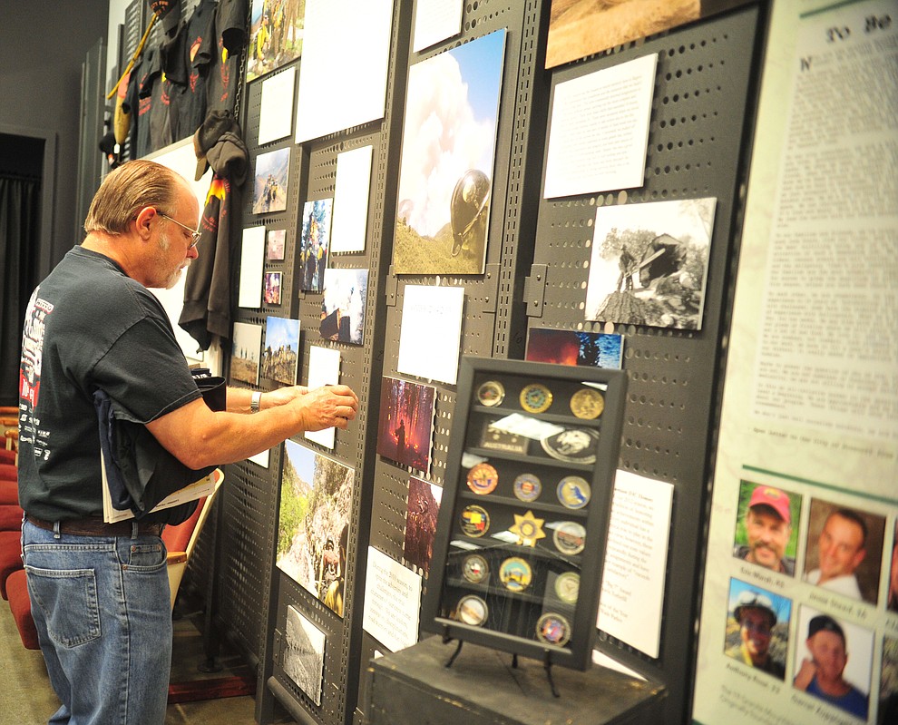 Mike Hazard from Prescott Valley, looks at a display as the Granite Mountain Interagency Hotshot Crew Learning and Tribute Center opens at the  Prescott Gateway Mall Friday, June 29, 2018.(Les Stukenberg/Courier)
