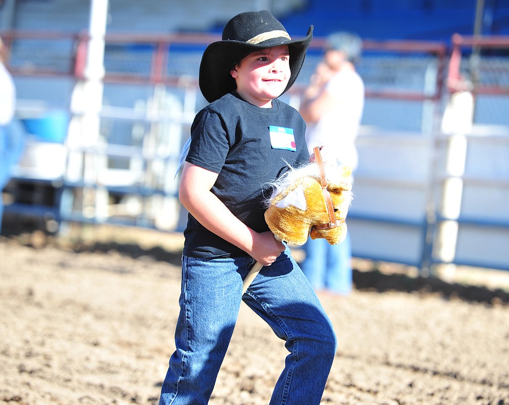 Jackson Hull is all smiles in his stick horse barrel race during the Happy Hearts Rodeo for exceptional children before the opening performance of the Prescott Frontier Days Rodeo Thursday, June 28, 2018. (Les Stukenberg/Courier)