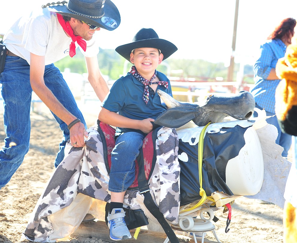 Gavin Bailey is all smiles on his bull ride during the Happy Hearts Rodeo for exceptional children before the opening performance of the Prescott Frontier Days Rodeo Thursday, June 28, 2018. (Les Stukenberg/Courier)