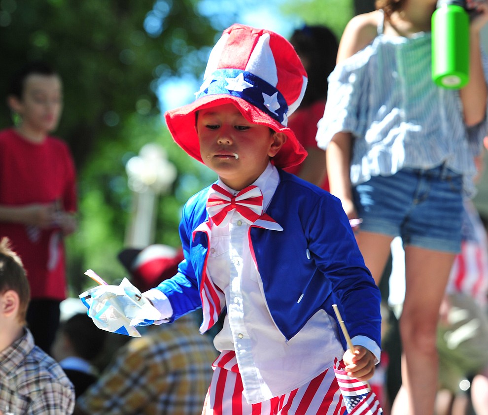 Even Uncle Sam enjoys an ice cream sandwich following the 77th annual Kiwanis Kiddie Parade in downtown Prescott Friday, June 29, 2018.(Les Stukenberg/Courier)
