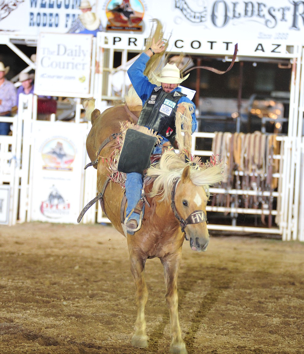 Tyler Baeza rides Sun Pop for a score of 78 in the saddle bronc during the opening performance of the Prescott Frontier Days Rodeo Thursday, June 28, 2018. (Les Stukenberg/Courier)