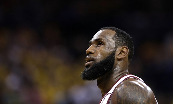 In this June 3, 2018, file photo, Cleveland Cavaliers forward LeBron James watches during the first half of Game 2 of basketball’s NBA Finals between the Golden State Warriors and the Cleveland Cavaliers in Oakland, Calif. Two people familiar with the decision say James has told the Cavaliers he is declining his $35.6 million contract option for next season and is a free agent. James’ representatives told the Cavs on Friday, June 29, 2018, said the people who spoke to the Associated Press on condition of anonymity because the team is not publicly commenting on moves ahead of free agency opening Sunday. (Marcio Jose Sanchez/AP, File)