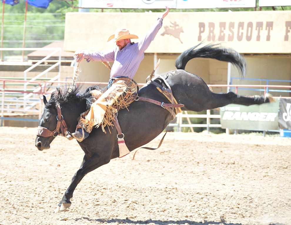 Kobyn Williams scores 82.5 on Mountain Climber in the saddle bronc riding during the third performance of the Prescott Frontier Days Rodeo Saturday, June 30, 2018.(Les Stukenberg/Courier)