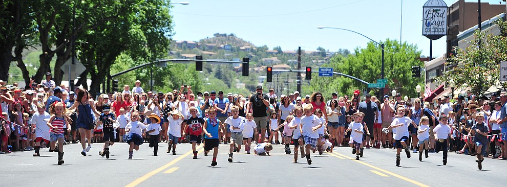 Large crowds watch the four to five year olds race during 36th annual Whiskey Row Boot Race along Montezuma Street in downtown Prescott Saturday, June 30, 2018.(Les Stukenberg/Courier)
