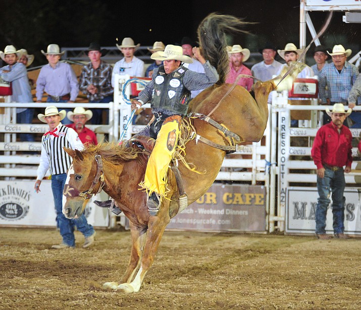 Jay Joaquin scores 85.5 on Snort in the saddle bronc during the 5th performance of the Prescott Frontier Days Rodeo Sunday, July 1, 2018. (Les Stukenberg/Courier)