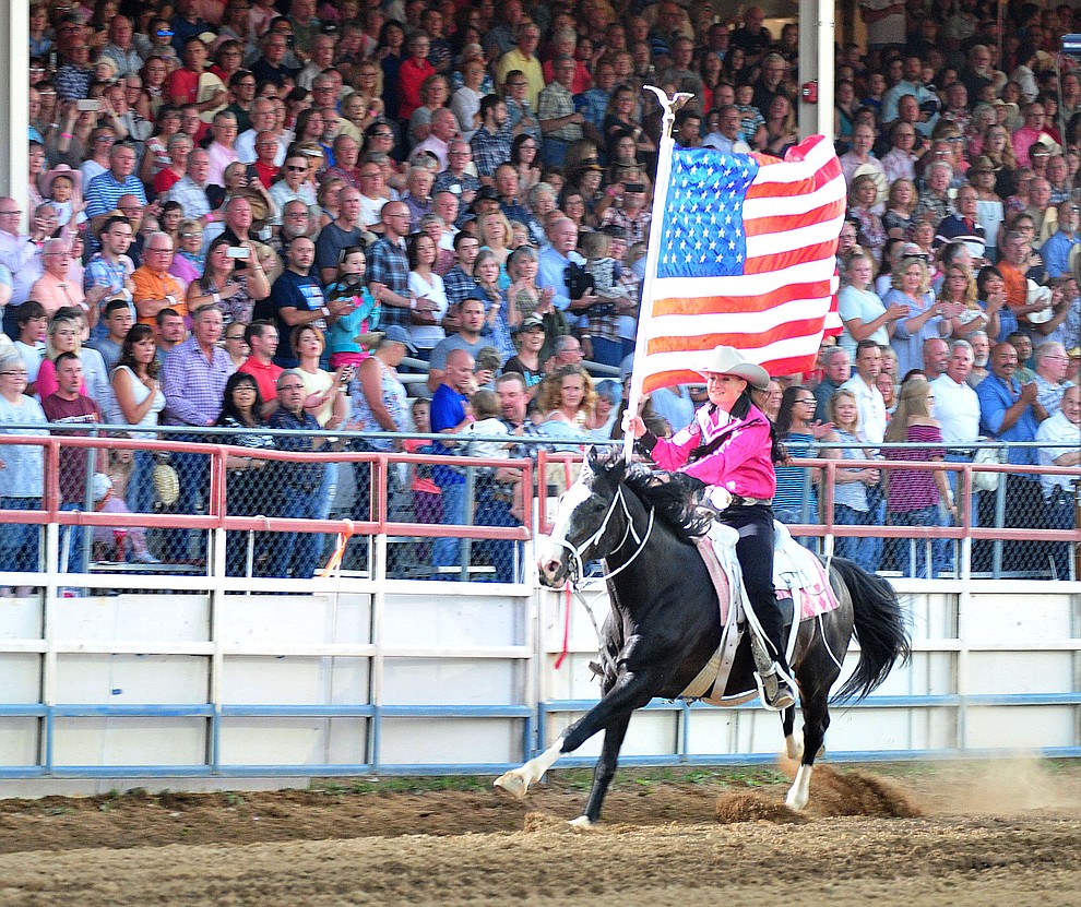 Sami Kilduff runs the American Flag during the 6th performance of the Prescott Frontier Days Rodeo Monday, July 2, 2018. (Les Stukenberg/Courier)
