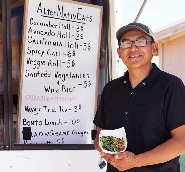  Carlos Deal serves sushi rolls at AlterNativeEats in Tuba City, Arizona. (Loretta Yerian/NHO) 