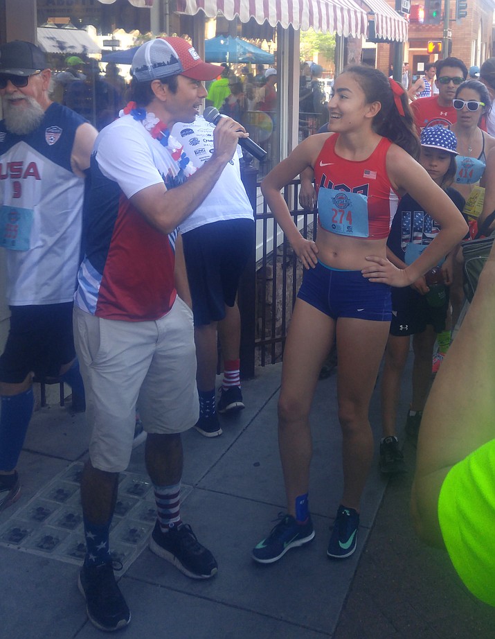 Cottonwood runner Allyson Arellano is interviewed by Hoka One One Northern AZ Elite Coach Ben Rosario following her win Wednesday in the women’s citizen division of the Flagstaff Downtown Mile. Arellano, who just finished her freshman season at Queens University of Charlotte in North Carolina, won the citizens race with a 5:32 clocking for the two-lap, 1-mile race, eclipsing the former course record of 5:36. Arellano forged a 3-second gap on her closest competitor through the first lap and ended up winning the race by 12 seconds. Photo courtesy of Micah Swenson.