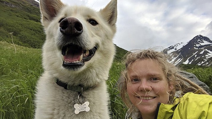 This Tuesday, June 19, 2018 photo by Amelia Milling shows her with a 7-year-old Alaskan husky named Nanook, that is credited with helping rescue her when she injured was hiking a trail in the Chugash State Park east of east of Anchorage, Alaska. Milling, a college student from Tennessee, was hiking the Crow Pass Trail and was injured early in the planned three-day hike. She says the white dog found her after she tumbled down a slope. Nanook’s owner Scott Swift says Nanook has been taking trips into Chugach State Park for years and accompanies hikers he meets on the trails. (Amelia Milling via AP)

