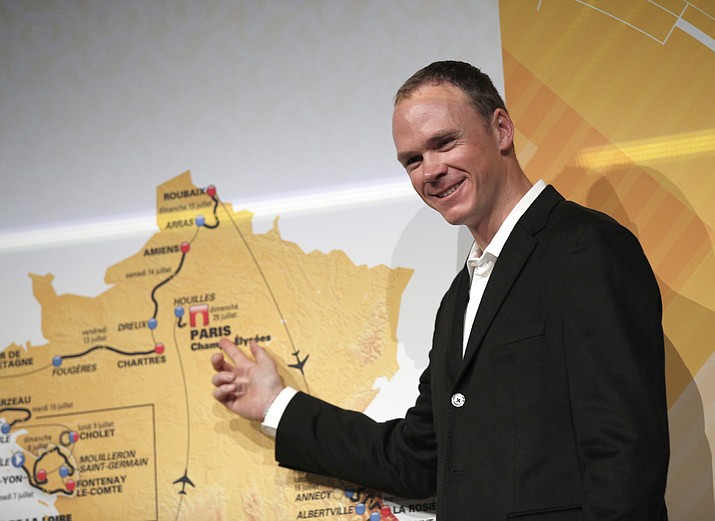 Britain’s Chris Froome as he poses in front of the the road-map during the presentation of the 2018 Tour de France cycling race, in Paris, France, ON OCT. 17, 2017. Twenty-one stages, 26 tough climbs across six mountain ranges, three mountain-top finishes and two time trials will test the limits of 176 riders’ endurance and skill in the Tour de France, which begins Saturday on Noirmoutier-en-l’Ile, an island off the west coast. (Christophe Ena/AP Photo, file)
