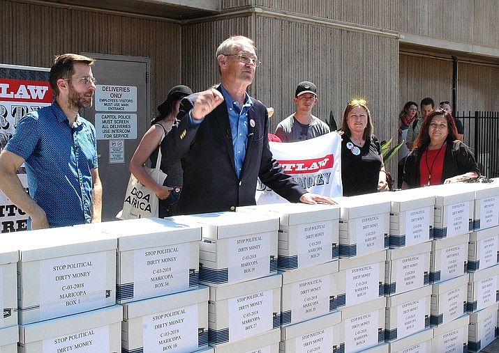 Flanked by supporters, former Attorney General Terry Goddard explains Thursday how an initiative drive would constitutionally require disclosure the original source of campaign contributions more than $10,000. Backers collected more than 285,000 signatures to put the issue on the November ballot. (Howard Fischer/Courtesy)
