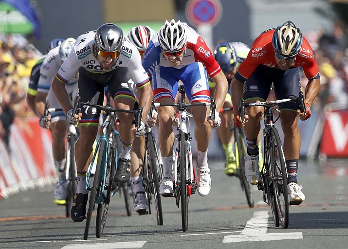 Slovakia’s Peter Sagan, left, Italy’s Sonny Colbrelli, right, and France’s Arnaud Demare sprint to the finish line during the finish line to win the second stage of the Tour de France cycling race over 182.5 kilometers (113.4 miles) with start in Mouilleron-Saint-Germain and finish in La Roche Sur-Yon, France, Sunday, July 8, 2018. Sagan won the stage. (Christophe Ena/AP Photo)