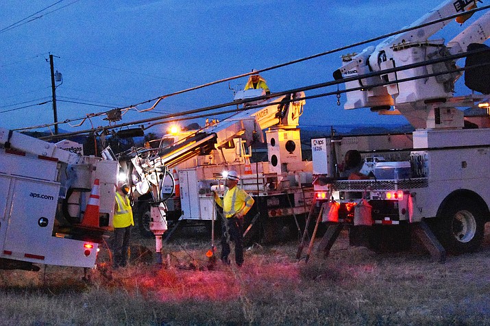 Arizona Public Service linemen drill a hole to erect a new power pole where one was knocked down on Highway 89 in Chino Valley Saturday night, July 7. (Richard Haddad/WNI)