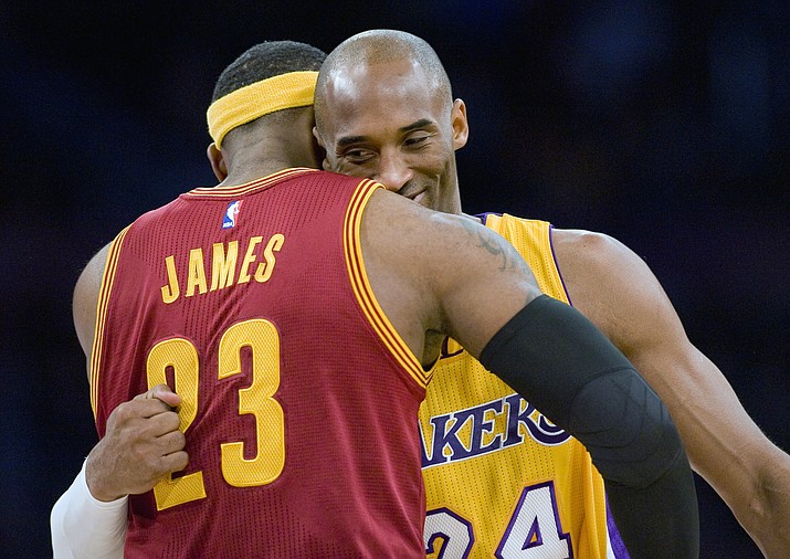 Los Angeles Lakers guard Kobe Bryant, right, and Cleveland Cavaliers forward LeBron James hug before the start of an NBA basketball game, in Los Angeles on Jan. 15, 2015. (Paul Rodriguez/The Orange County Register via AP, FIle)