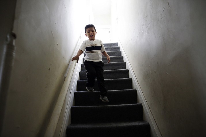 Franco Perez cries as he runs downstairs from his family's apartment in Covington, Ky., on April 28, 2018, looking for his father, Edgar Perez Ramirez, who had walked outside for a moment. Months after U.S. Immigration and Customs Enforcement agents arrested his father, the 4-year-old still shows more aggression toward his classmates and panics if his father leaves him for more than a few minutes. (AP Photo/Gregory Bull)

