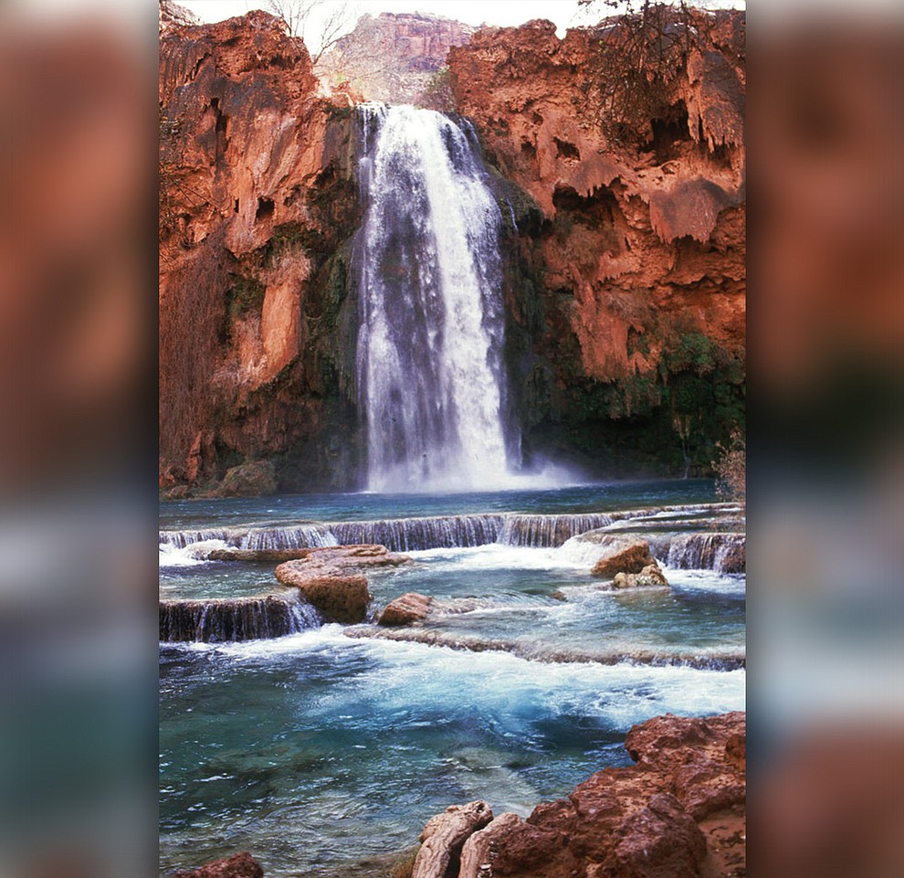FILE - This 1993 file photo shows Havasu Falls in the Grand Canyon, Ariz. About 200 tourists are being evacuated from a campground on tribal land near famous waterfalls deep in a gorge off the Grand Canyon. Officials with the Havasupai Tribe say their reservation was hit with two rounds of flooding Wednesday, July 11, 2018, and early Thursday. (The Arizona Republic via AP, File)