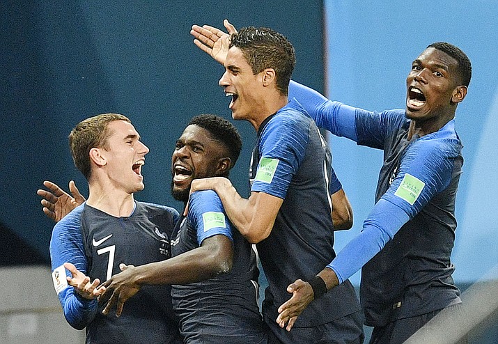 France's Samuel Umtiti, second from left, is congratulated by his teammates France's Antoine Griezmann, Raphael Varane and Paul Pogba, from left, after scoring the opening goal during the semifinal match between France and Belgium at the 2018 soccer World Cup in St. Petersburg, Russia, Tuesday, July 10, 2018. (Martin Meissner/AP)