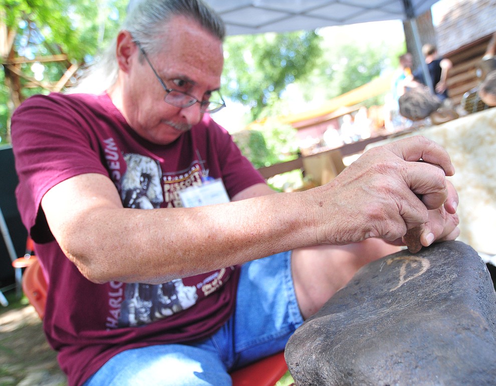 Choctaw Dave Morris petroglyph carving at the 21st annual Indian Arts Market at the Sharlot Hall Museum Saturday, July 14, 2018. The market continues today from 9:00 - 4:00. (Les Stukenberg/Courier)