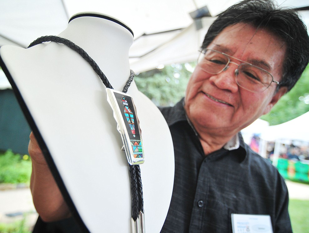 Featured artist Navajo Jim Harrison with an intricate inlaid bolo at the 21st annual Indian Arts Market at the Sharlot Hall Museum Saturday, July 14, 2018. The market continues today from 9:00 - 4:00. (Les Stukenberg/Courier)