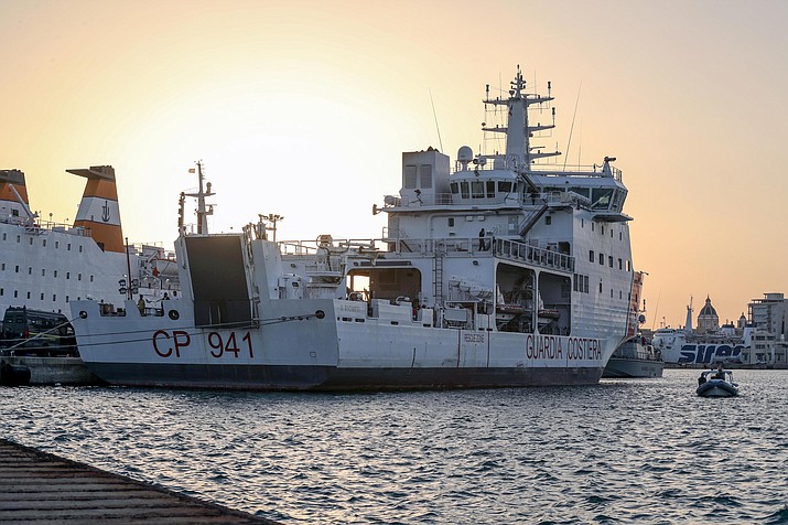 The Diciotti ship of the Italian Coast Guard, with 67 migrants on board rescued 4 days ago by the Vos Thalassa freighter, is moored in the Sicilian port of Trapani, southern Italy, Thursday, July 12, 2018. An Italian coast guard ship has docked in Sicily but is still awaiting permission to disembark its 67 migrants, after two of them were accused of threatening their rescuers if they were taken back to Libya. Interior Minister Matteo Salvini said Thursday he won't let the migrants off until there is clarity over what happened after an Italian commercial tugboat rescued them over the weekend. Italy's transport minister said some migrants made death threats against the crew. The threats prompted the Italian coast guard to board the migrants and bring them to Trapani. (Igor Petyx/ANSA via AP)

