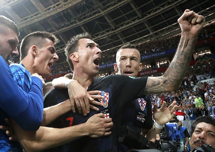 Croatia’s Mario Mandzukic, center, celebrates after scoring his side’s second goal during the semifinal match between Croatia and England at the 2018 soccer World Cup in the Luzhniki Stadium in Moscow, Russia, Wednesday, July 11, 2018. (AP Photo/Frank Augstein)