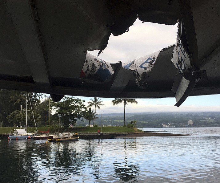 This photo provided by the Hawaii Department of Land and Natural Resources shows damage to the roof of a tour boat after an explosion sent lava flying through the roof off the Big Island of Hawaii Monday, July 16, 2018, injuring at least 23 people. The lava came from the Kilauea volcano, which has been erupting from a rural residential area since early May. (Hawaii Department of Land and Natural Resources via AP)

