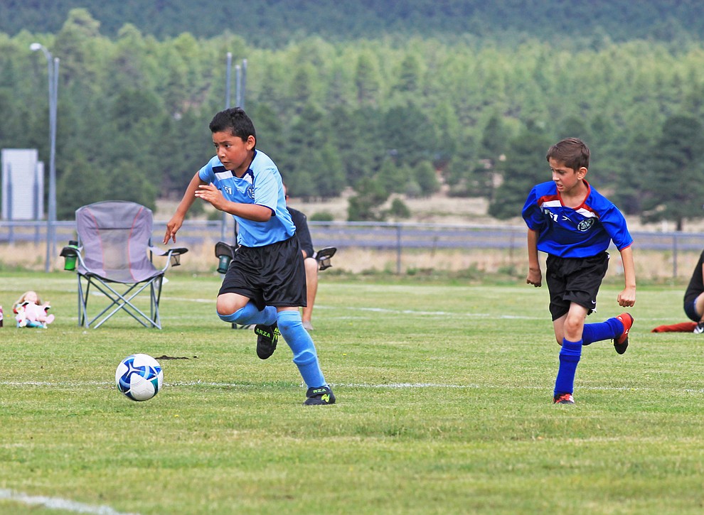 A Williams AYSO player battles for the ball in a game against Flagstaff July 14 at the WEMS field.
