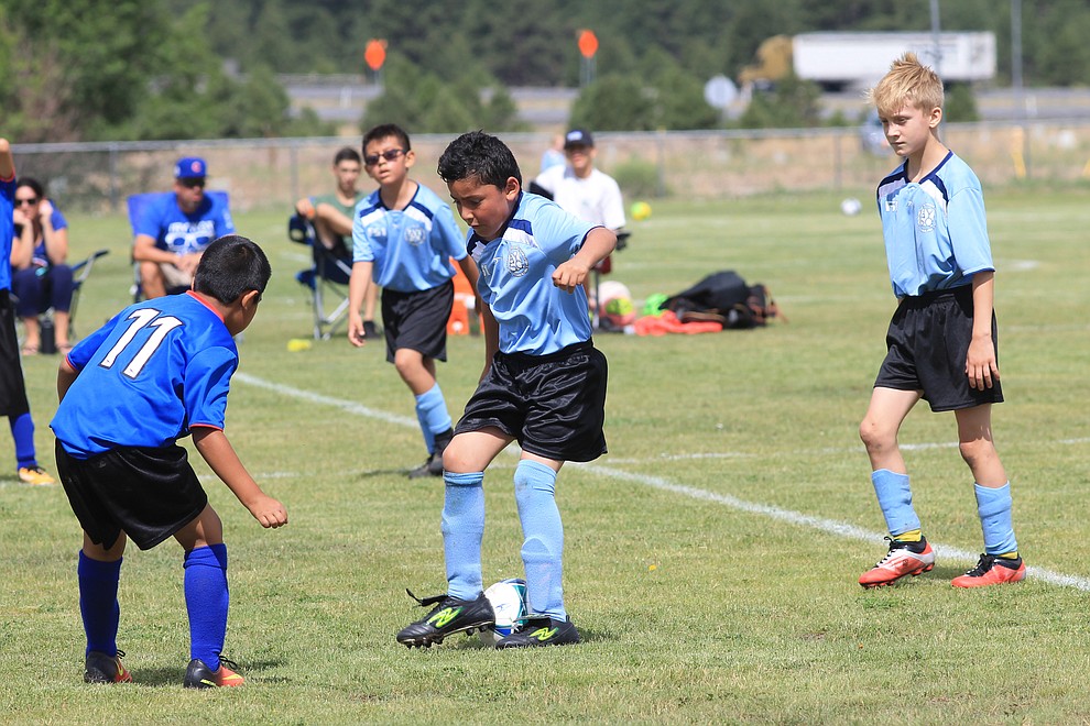 Williams AYSO players battle for the ball in a game against Flagstaff July 14 at the WEMS field.