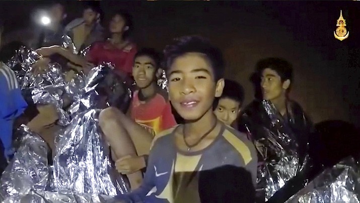 In this July 3, 2018, image taken from video provided by the Royal Thai Navy Facebook Page, Thai boys smile as a Thai Navy SEAL medic was helping injured children while they were trapped inside a cave in Mae Sai, northern Thailand. (Royal Thai Navy Facebook Page)	
