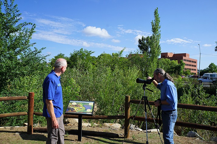 Eric Moore, owner of Jay’s Bird Barn, left, and Michael Byrd, the executive director of the Prescott Creeks organization, check out the new optical equipment that was donated to the organization by the Vortex Optics company. The equipment was among the needs that Prescott Creeks had after a December 2017 fire destroyed its log-cabin office along Highway 89. (Cindy Barks/Courier, file)