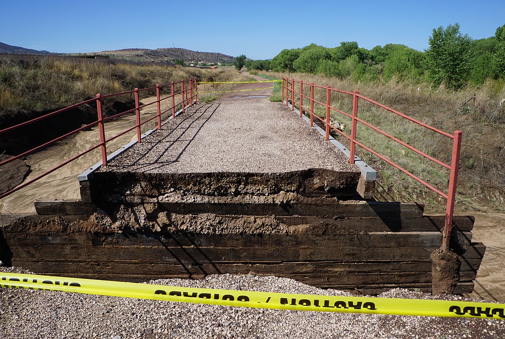 Caution tape alerts trail users to the damage that occurred along the Peavine Trail in northeast Prescott Wednesday, July 18. The nearby Sundog Weather Station measured 3.1 inches of rain Thursday morning. (Cindy Barks/Courier)