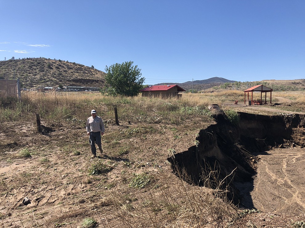 City of Prescott Trails and Natural Parklands Coordinator Chris Hosking looks at some of the damage done to the Peavine Trail from the recent monsoon storms in Prescott, AZ. (Cindy Barks/Courier)