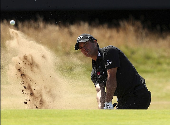 Kevin Kisner of the US chips out of a bunker on the 18th hole during the first round of the British Open Golf Championship in Carnoustie, Scotland, Thursday July 19, 2018. (Jon Super/AP)