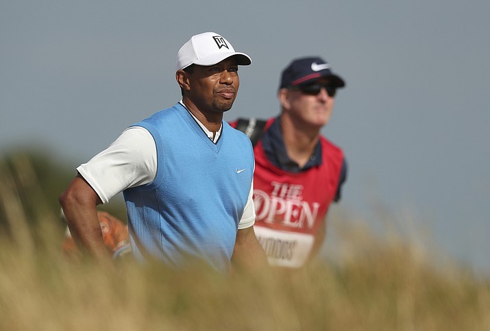 Tiger Woods of the US and his caddie Joe Lacava walk along the 7the fairway during the first round of the British Open Golf Championship in Carnoustie, Scotland, Thursday July 19, 2018. (Jon Super/AP)