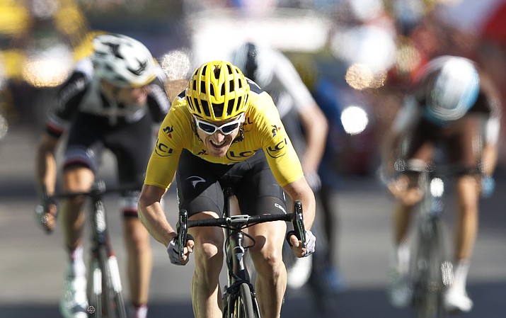 Britain's Geraint Thomas, wearing the overall leader's yellow jersey speeds to the finish line to win the twelfth stage of the Tour de France cycling race over 175.5 kilometers (109 miles) with start in Bourg-Saint-Maurice Les Arcs and Alpe d'Huez, France, Thursday, July 19, 2018. (Christophe Ena/AP)