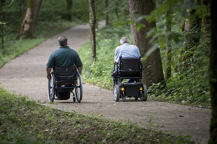 David Allgood and Tom Stokes use a trail adapted for persons with disabilities at Mammoth Cave National Park in Cave City, Ky., Friday.  (Bryan Woolston/AP)