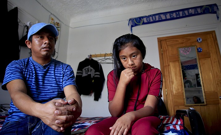Manuel Marcelino Tzah, left, and his daughter Manuela Adriana, 11, sit inside their apartment during an interview hours after her release from immigrant detention, Wednesday July 18, 2018, in Brooklyn borough of New York. The Guatemalan asylum seekers were separated May 15 after they crossed the U.S. border in Texas. (Bebeto Matthews/AP)