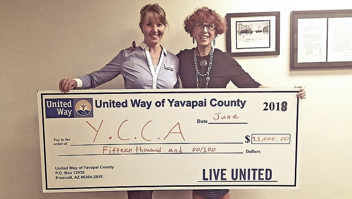 United Way of Yavapai County Executive Director Annette Olson presents an oversized check of $15,000 to Yavapai County Contractors Associations Executive Director Sandy Griffis for a new workforce boot camp project to be held in January. (Courtesy)