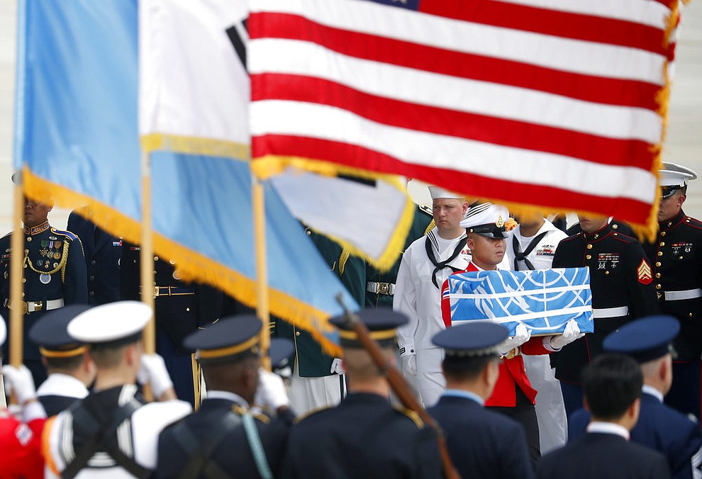 A soldier carries a casket containing a remain of a U.S. soldier who was killed in the Korean War during a ceremony at Osan Air Base in Pyeongtaek, South Korea, Friday, July 27, 2018.  The U.N. Command says the 55 cases of war remains retrieved from North Korea will be honored at a ceremony next Wednesday at a base in South Korea. (Kim Hong-Ji/Pool Photo via AP)
