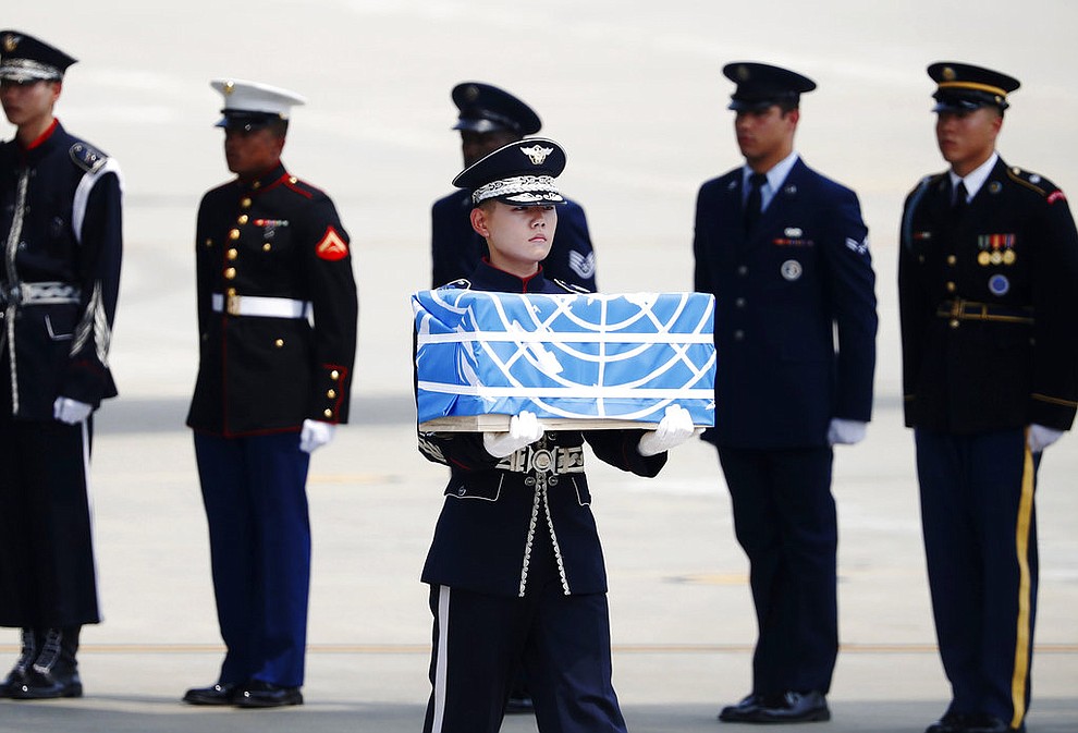 A soldier carries a casket containing a remain of a U.S. soldier who was killed in the Korean War during a ceremony at Osan Air Base in Pyeongtaek, South Korea, Friday, July 27, 2018.  The U.N. Command said the 55 cases of war remains retrieved from North Korea will be honored at a ceremony next Wednesday at a base in South Korea. (Kim Hong-Ji/Pool Photo via AP)