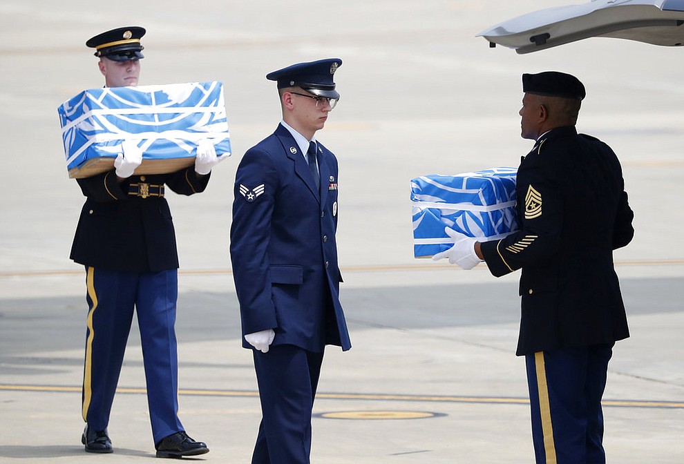 Soldiers carry caskets containing remains of U.S. soldiers who were killed in the Korean War during a ceremony at Osan Air Base in Pyeongtaek, South Korea, Friday, July 27, 2018. North Korea on Friday returned the remains of what are believed to be U.S. servicemen killed during the Korean War, the White House said, with a U.S military plane making a rare trip into North Korea to retrieve 55 cases of remains. (Kim Hong-Ji/Pool Photo via AP)